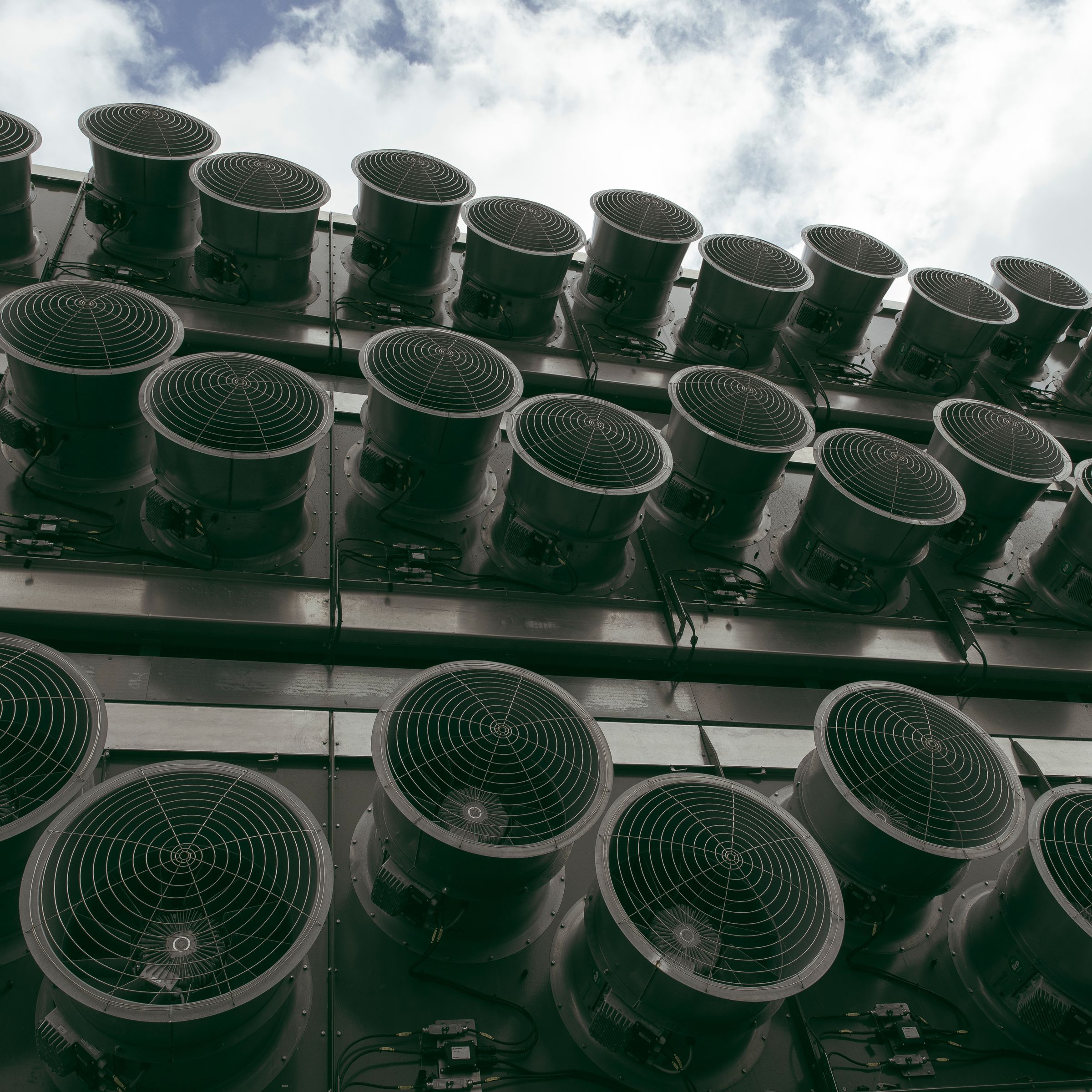 Rows of fans seen on the facade of an industrial plant.