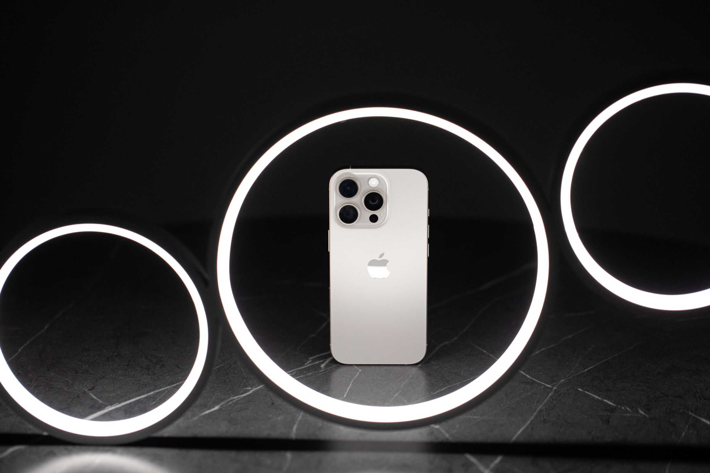 The iPhone 16 Pro in a ring-shaped LED light fixture.