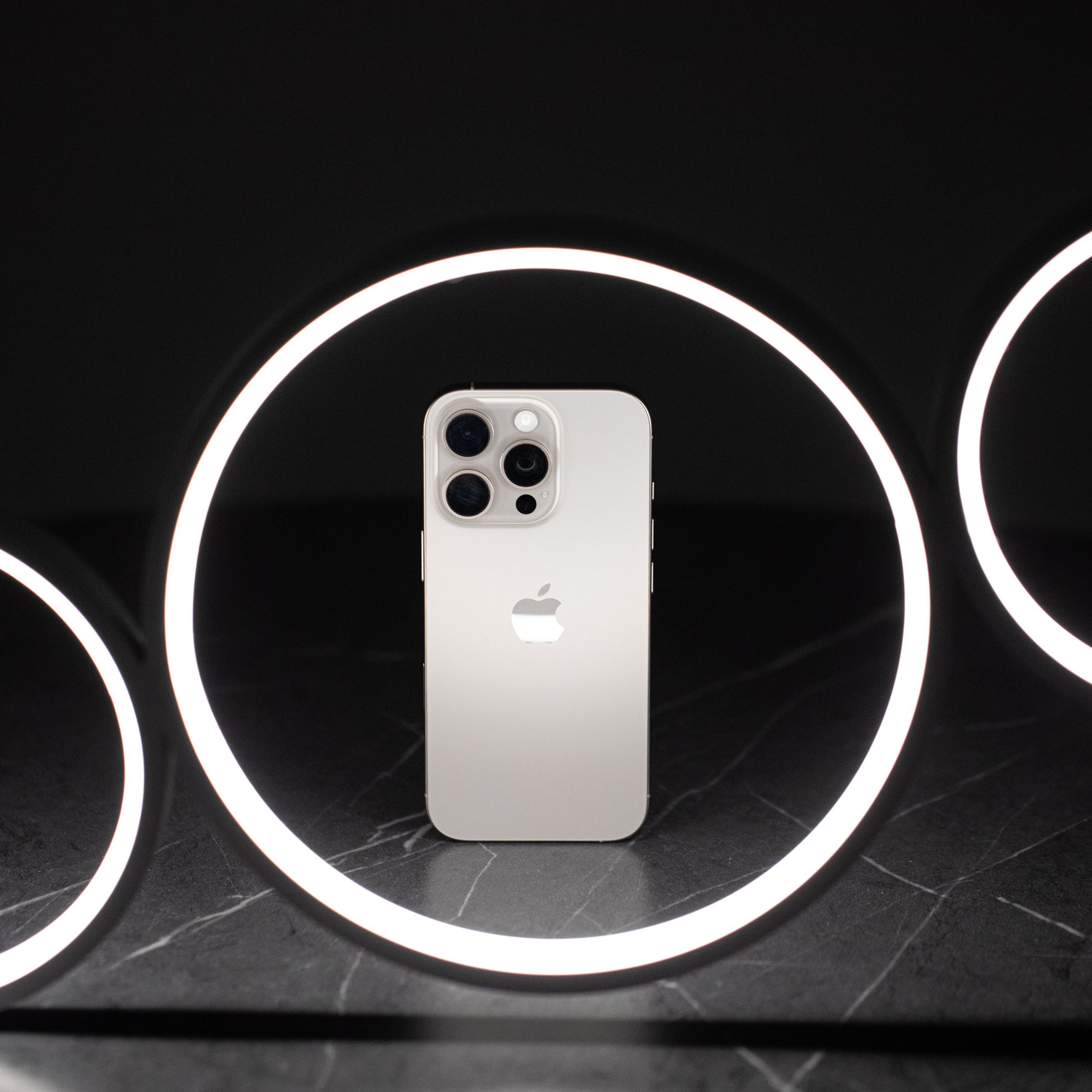 The iPhone 16 Pro in a ring-shaped LED light fixture.