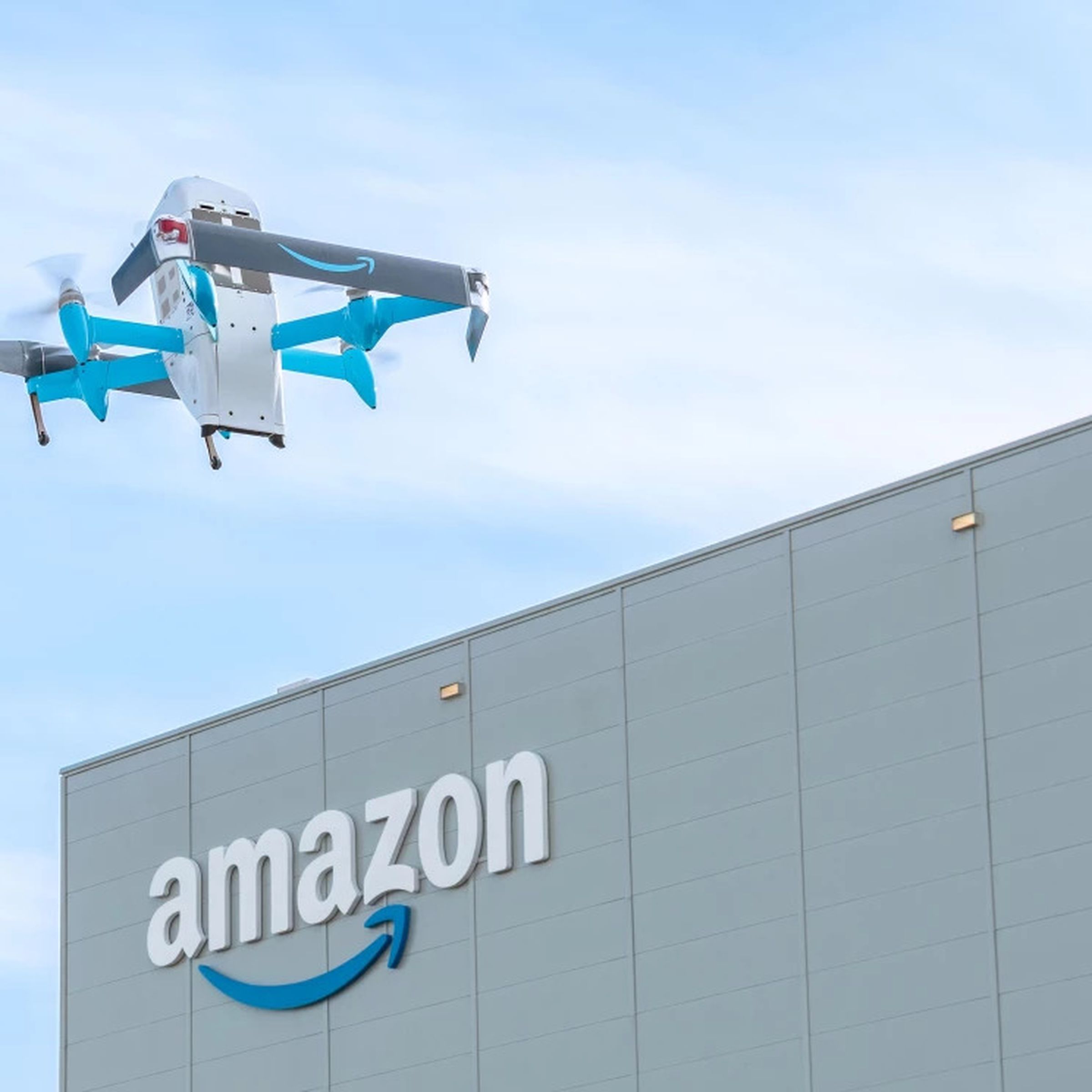 drone in sky with amazon building in background