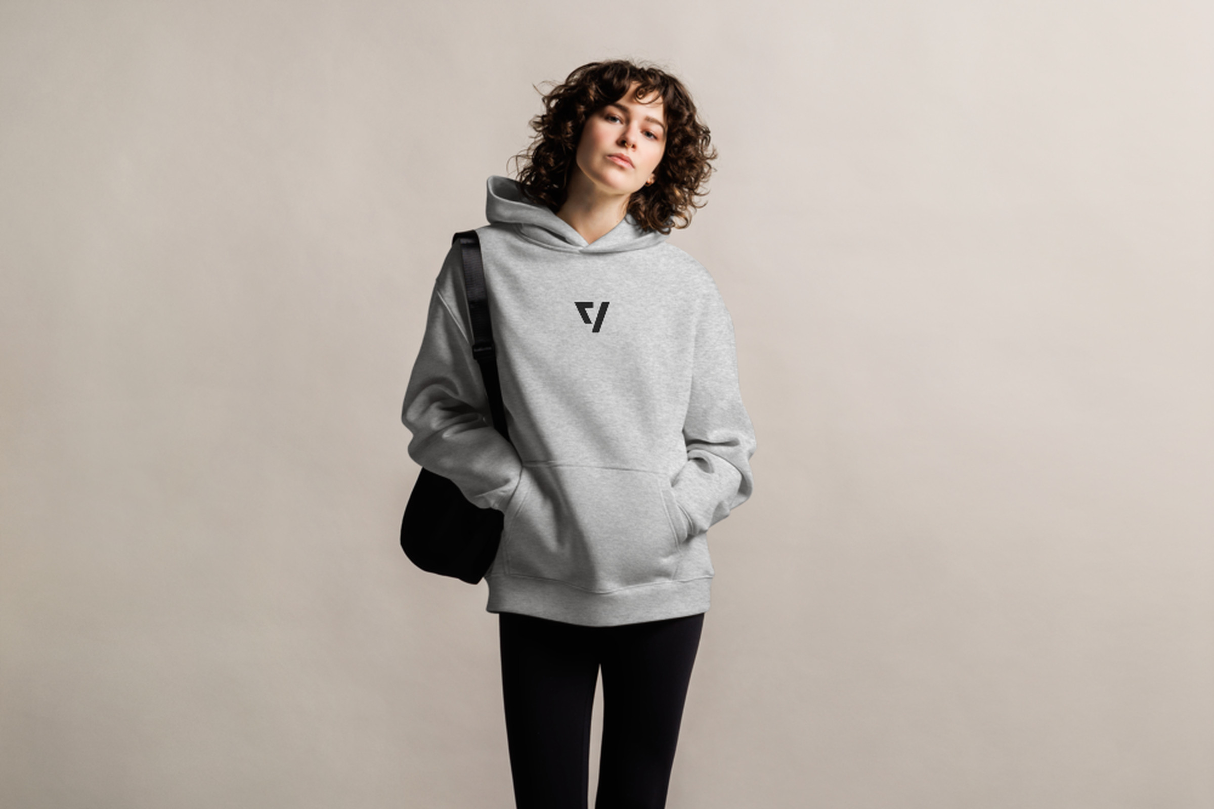 Woman wearing The Verge hoodie in gray