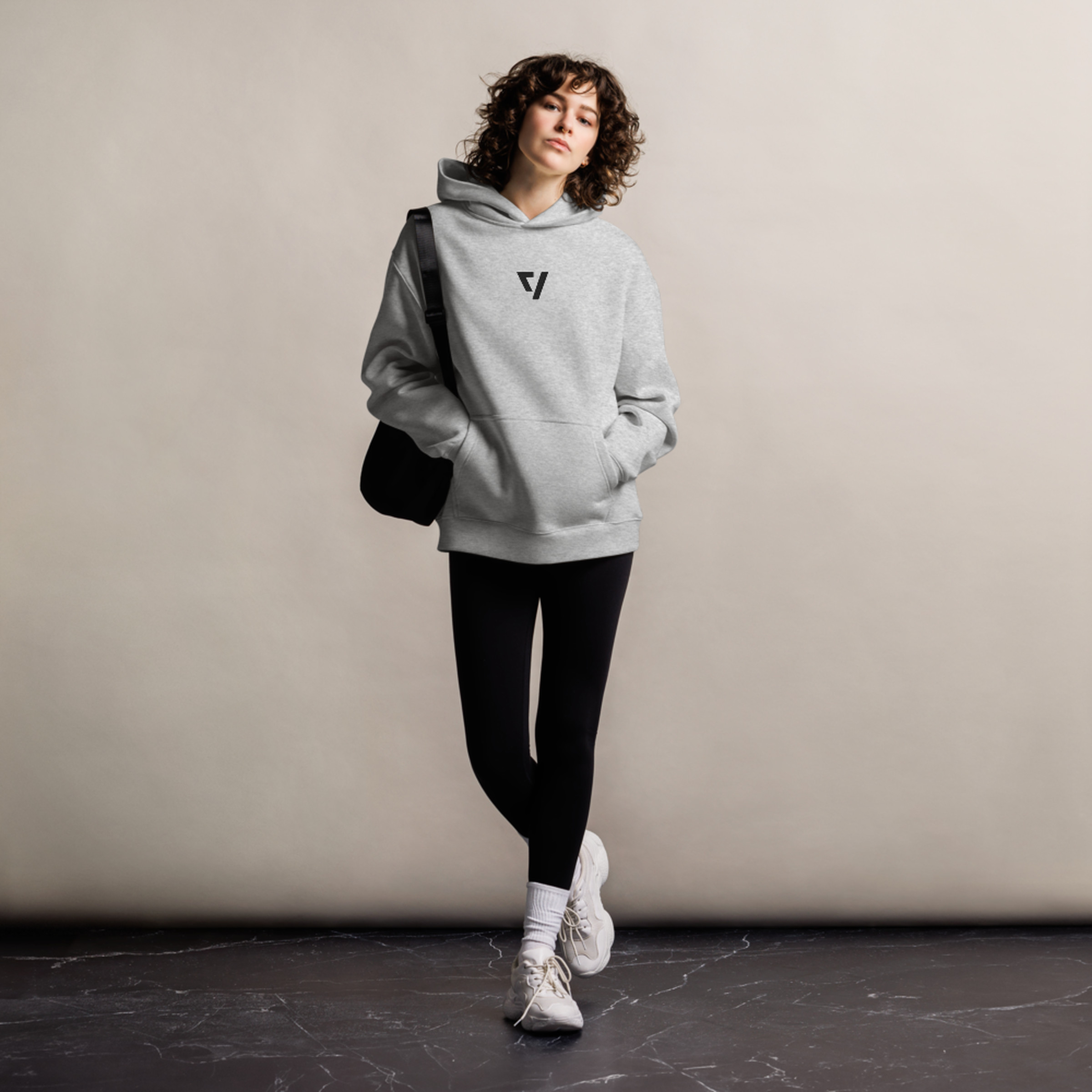 Woman wearing The Verge hoodie in gray