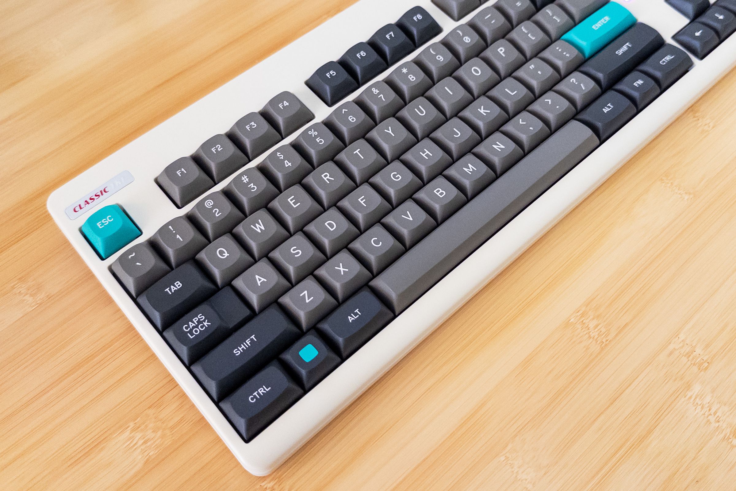 Top-down view of a retro beige keyboard with black and gray keycaps.