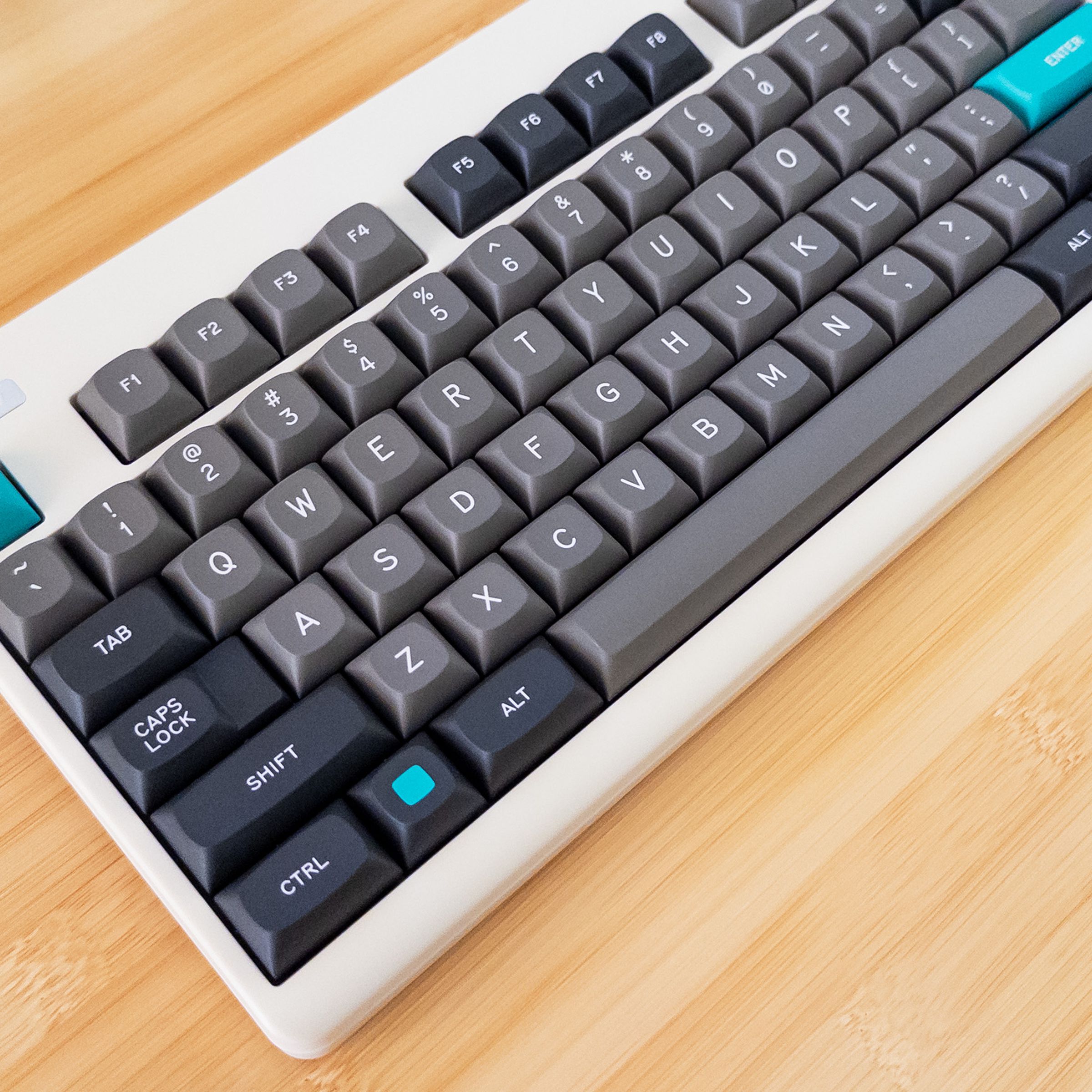 Top-down view of a retro beige keyboard with black and gray keycaps.