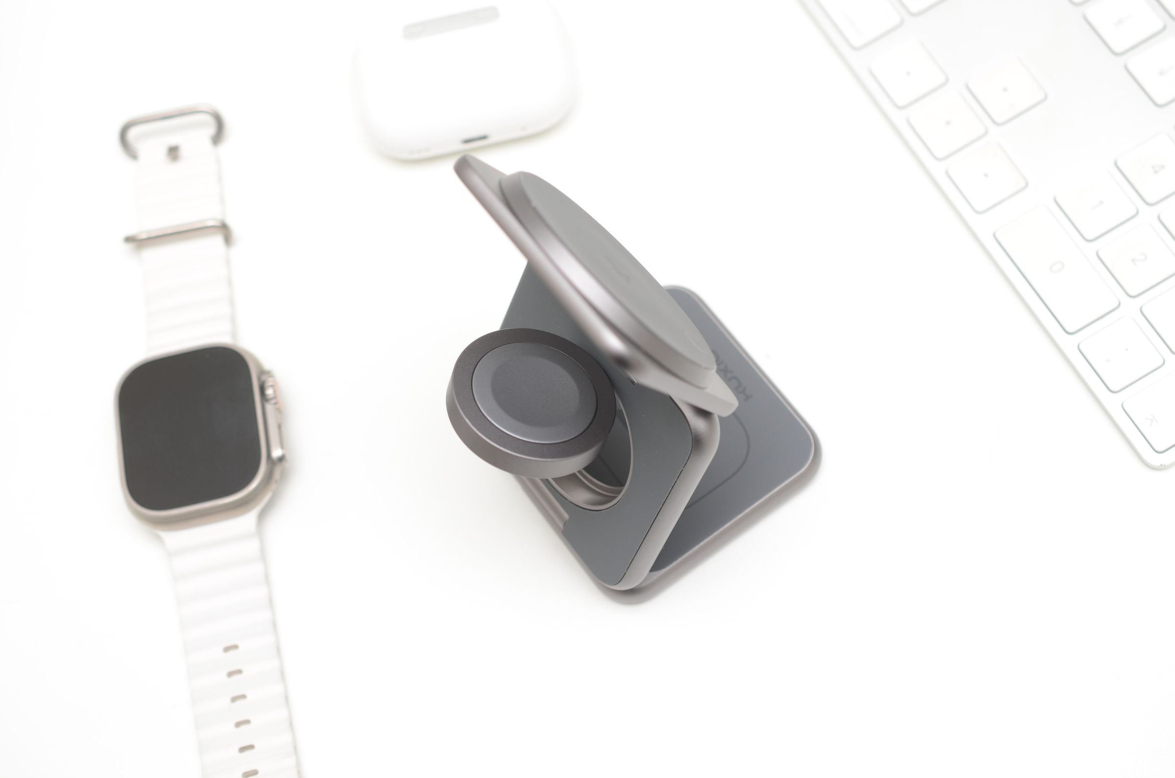 <em>A reasonably strong MagSafe-compatible magnet holds the iPhone in place vertically or horizontally to take advantage of StandBy mode. There’s a weaker magnet on the folding Apple Watch puck, while the AirPods are held in place by gravity.</em>