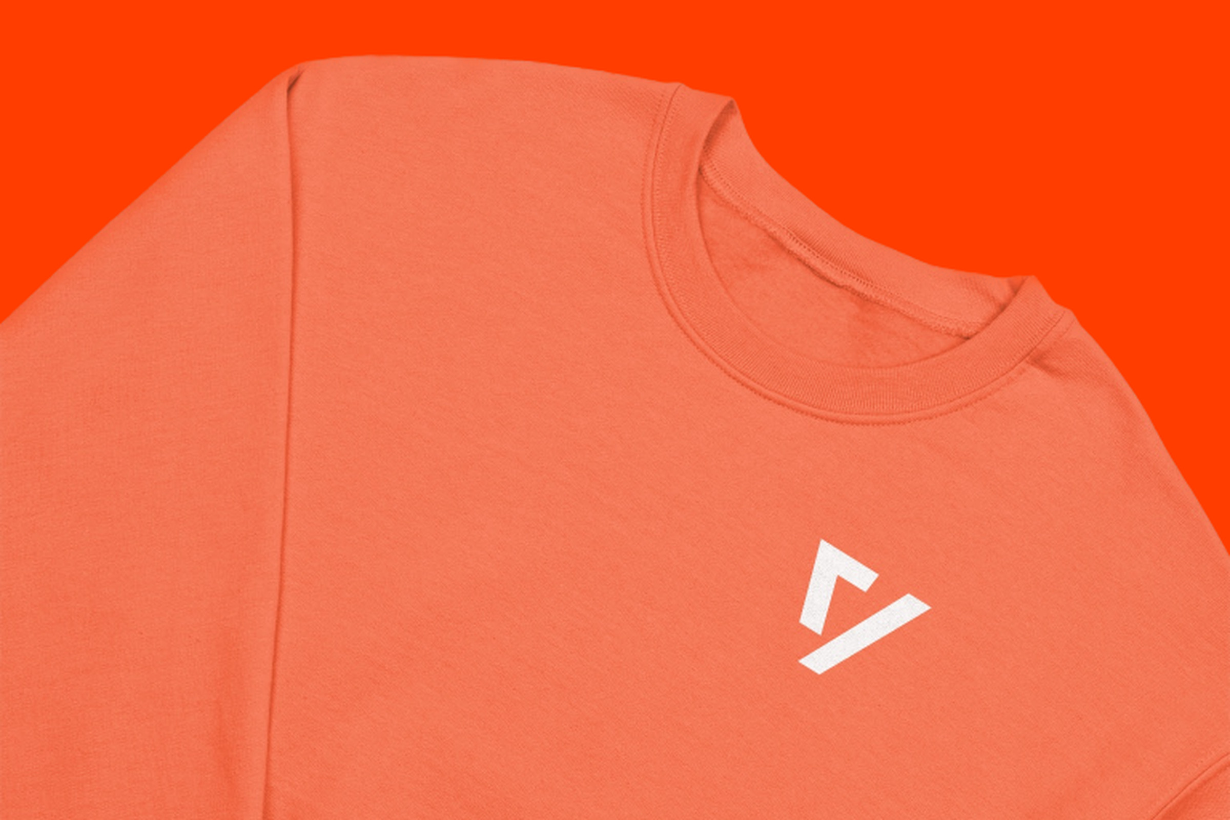 An orange crewneck with The Verge logo on an orange background