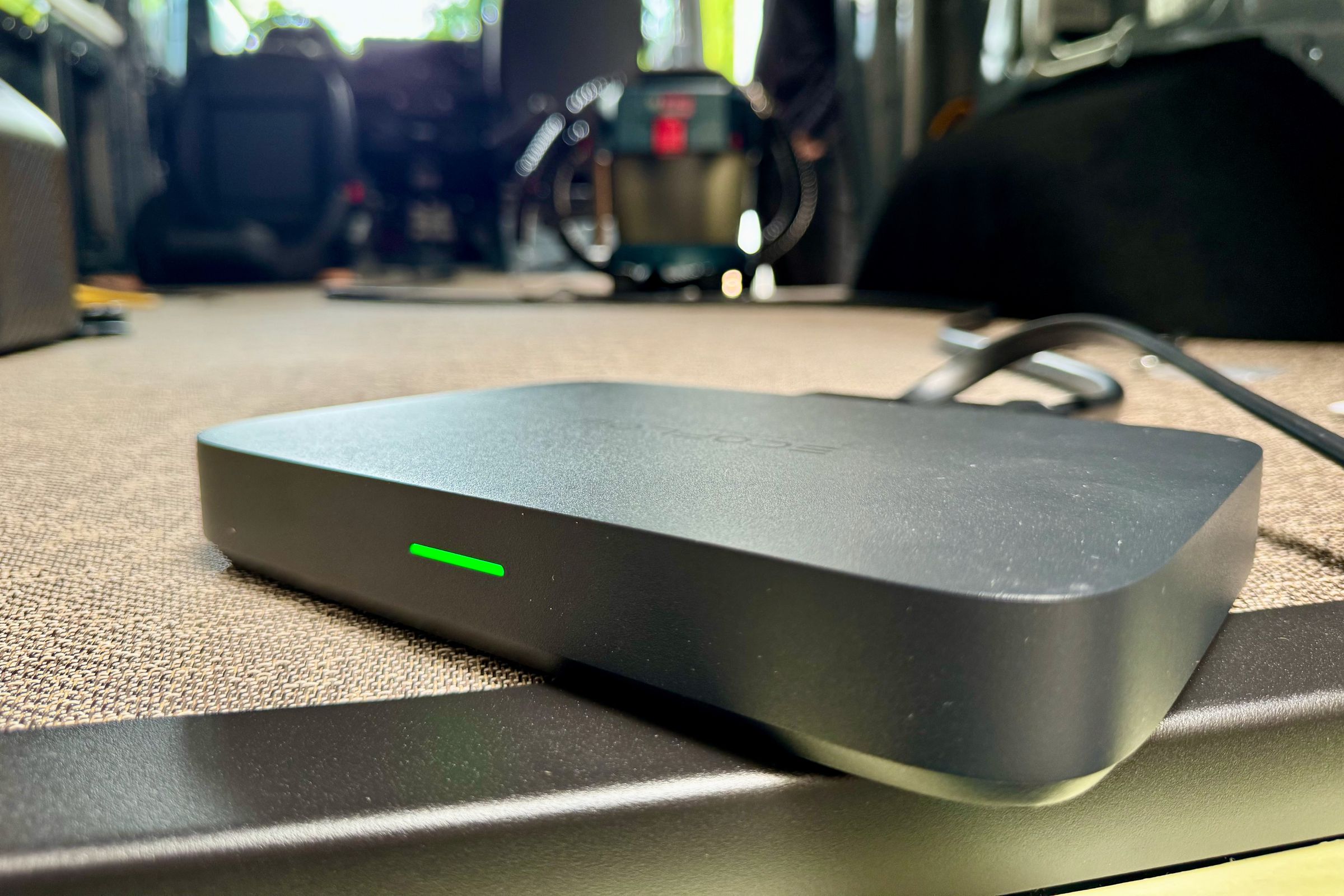 EcoFlow’s Alternator Charger sits in the back of a Sprinter cargo van with the interior visible in the blurred background.