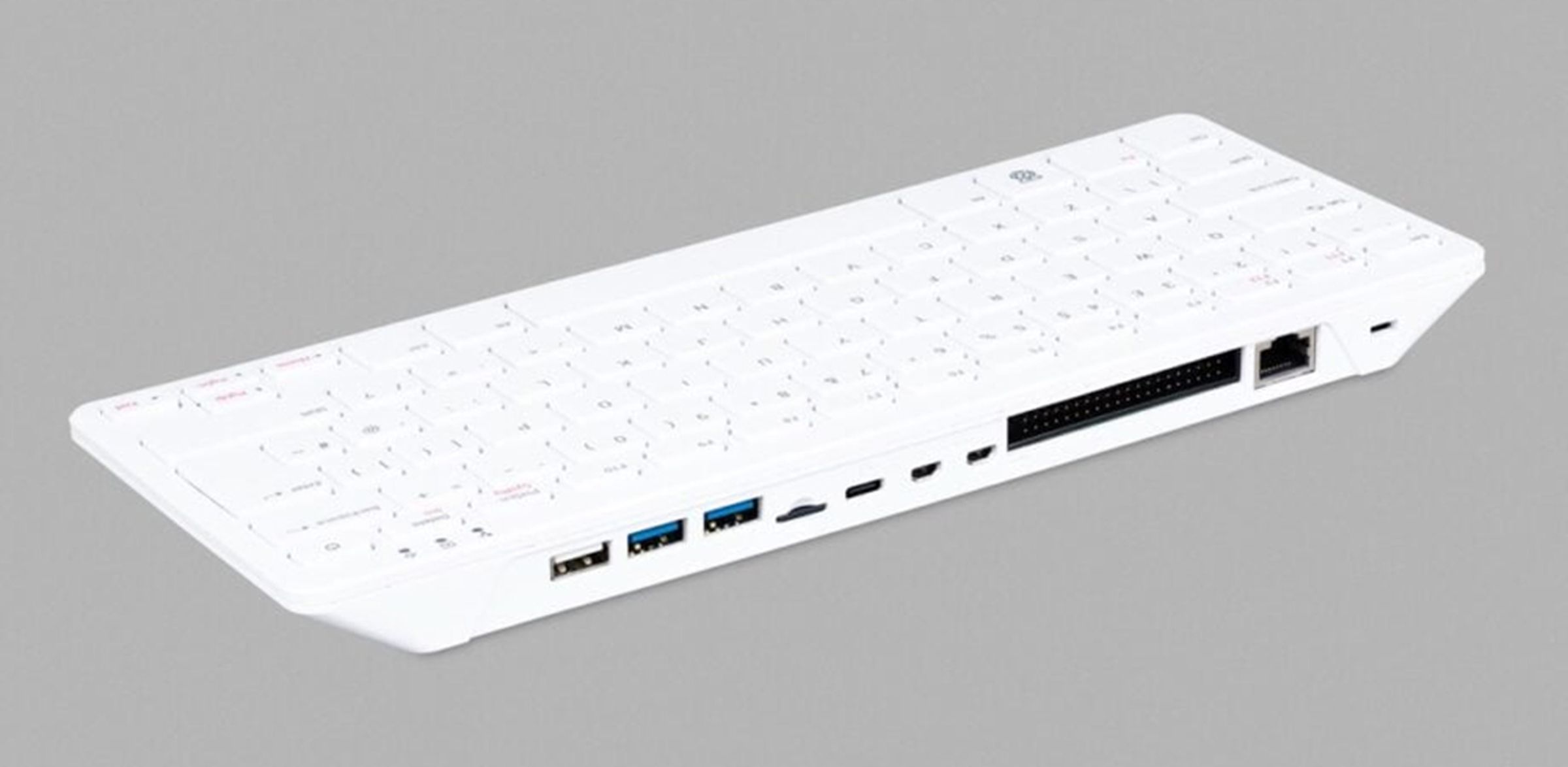 The Raspberry Pi 500 computer keyboard against a gray background.