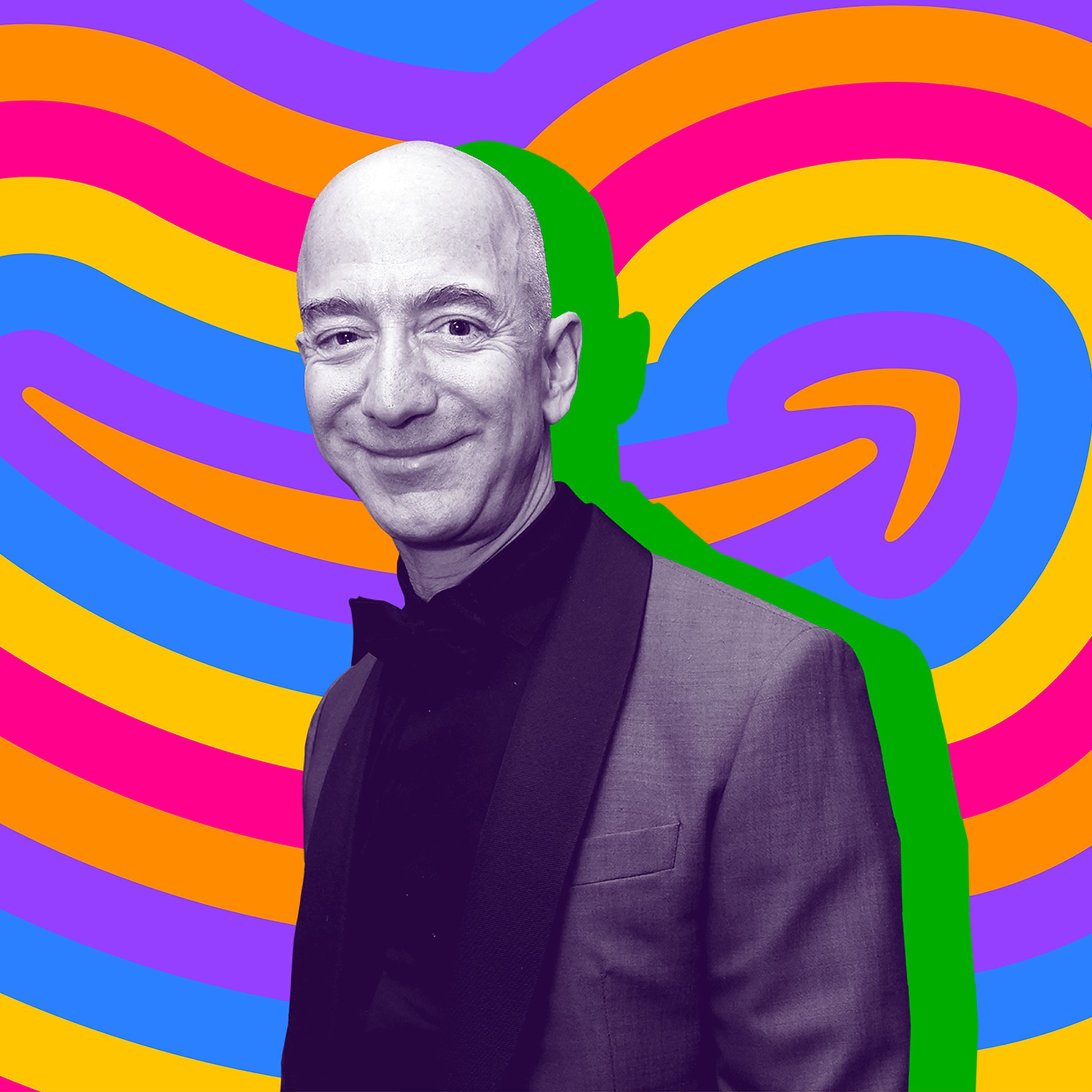 Jeff Bezos stands in front of an Amazon logo